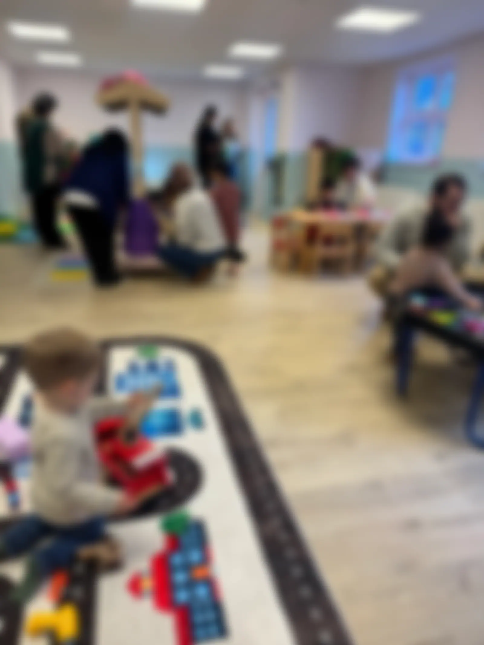 Families exploring the play room at the opening