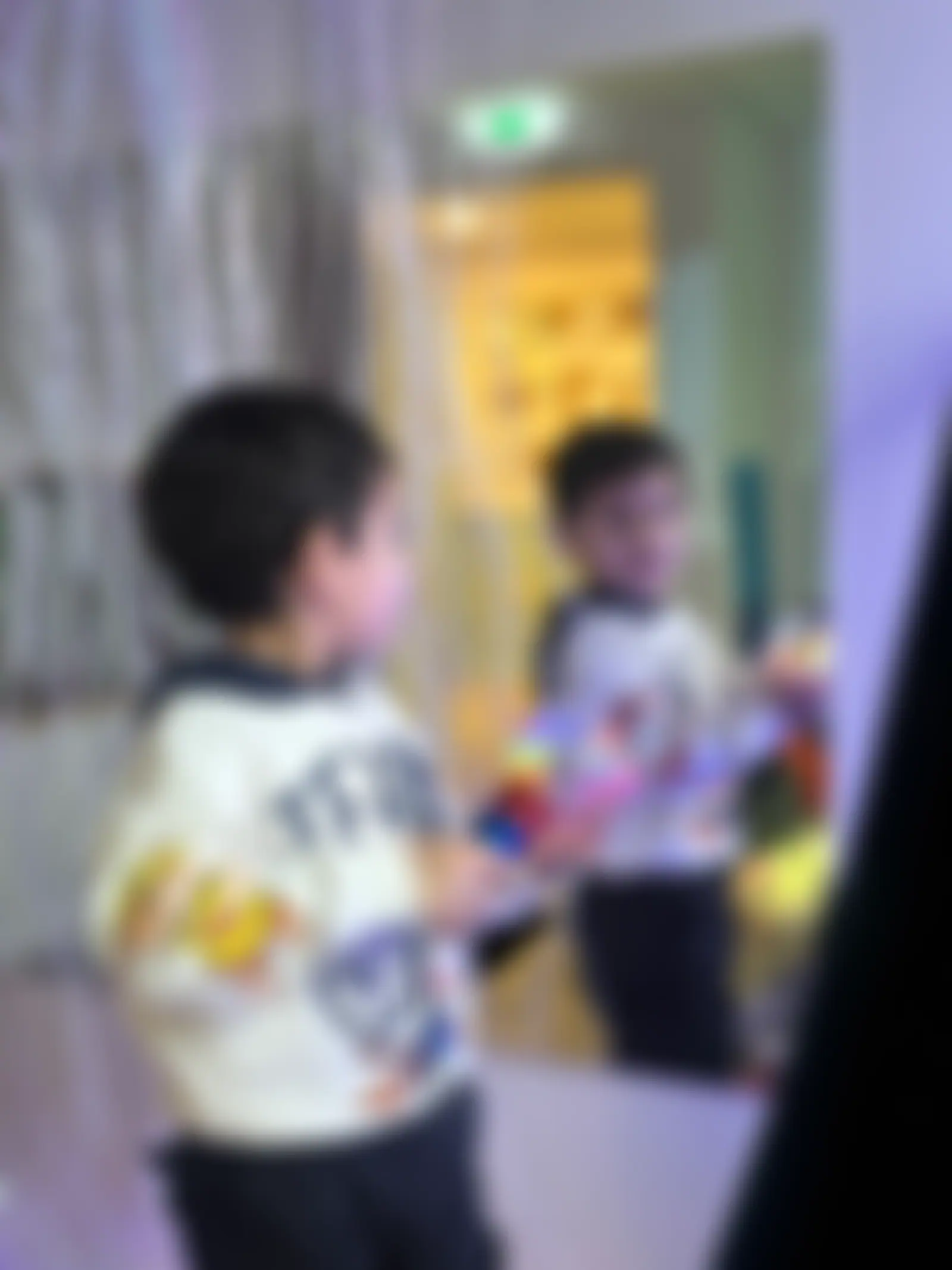 Two children exploring the fibre-optic light curtain