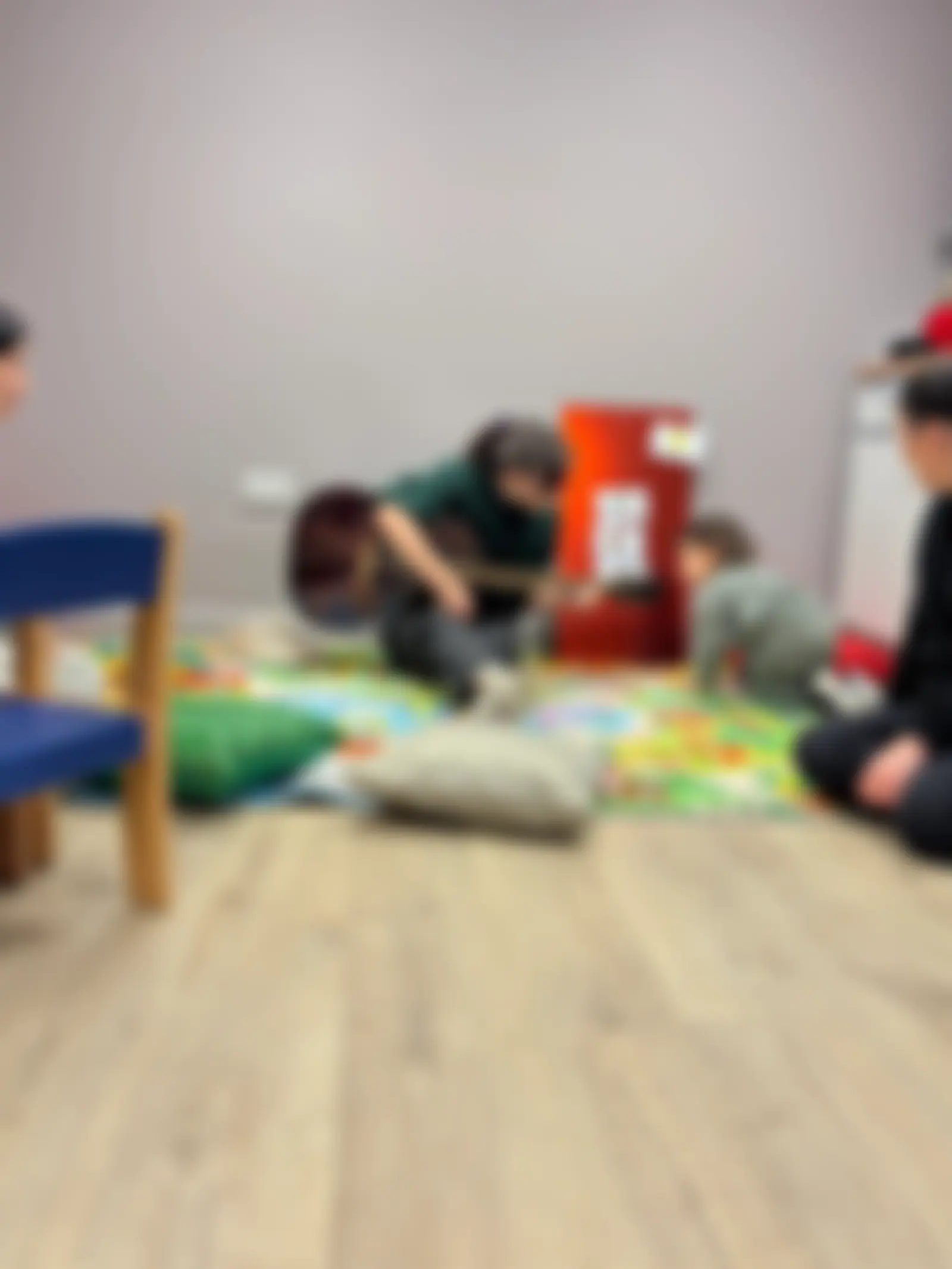 Families playing together on the floor mats