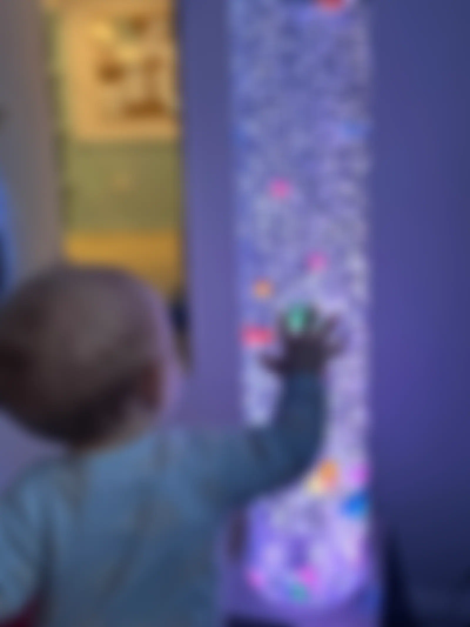 Toddler reaching out to touch the bubble tube