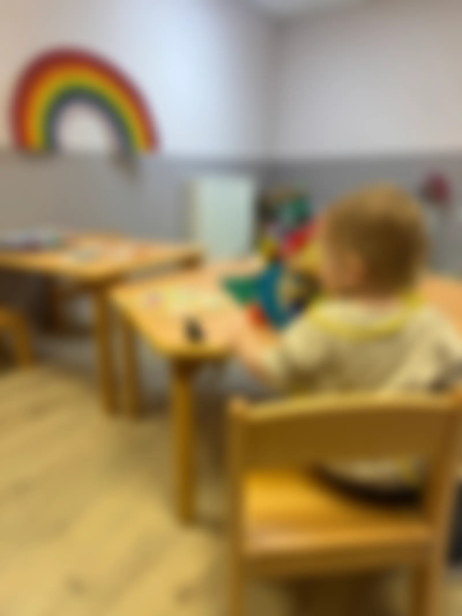 Toddler working on a wooden puzzle at the table