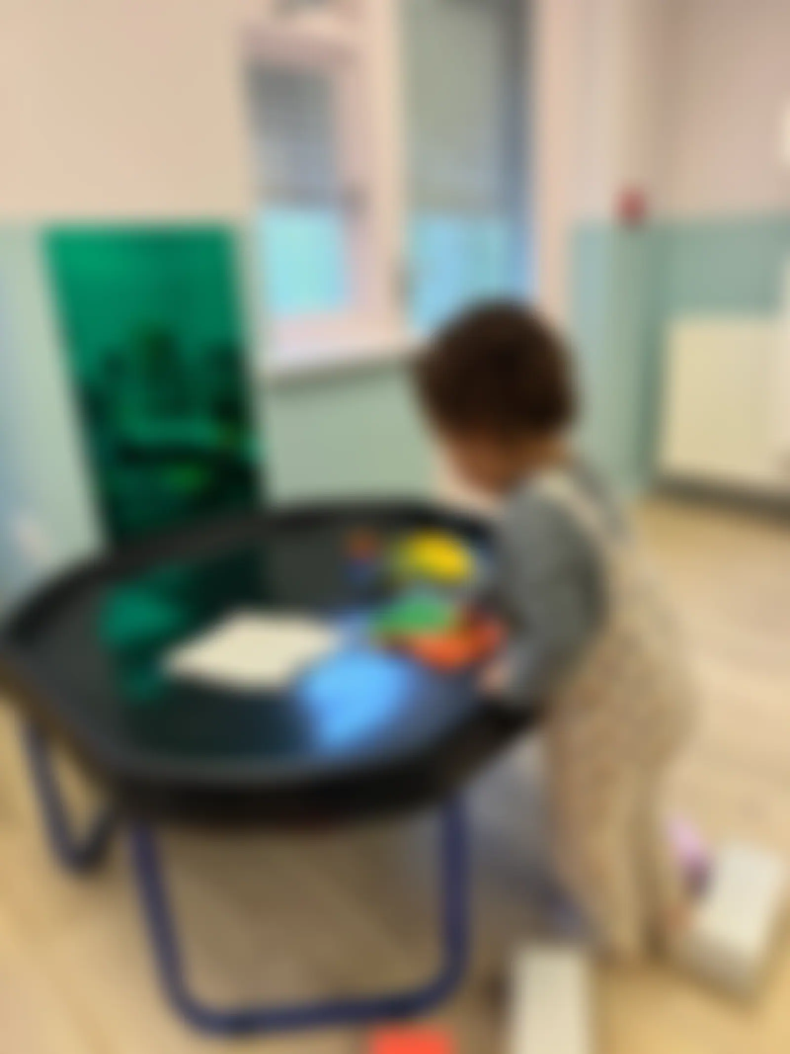 Child mark-making at a tuff tray