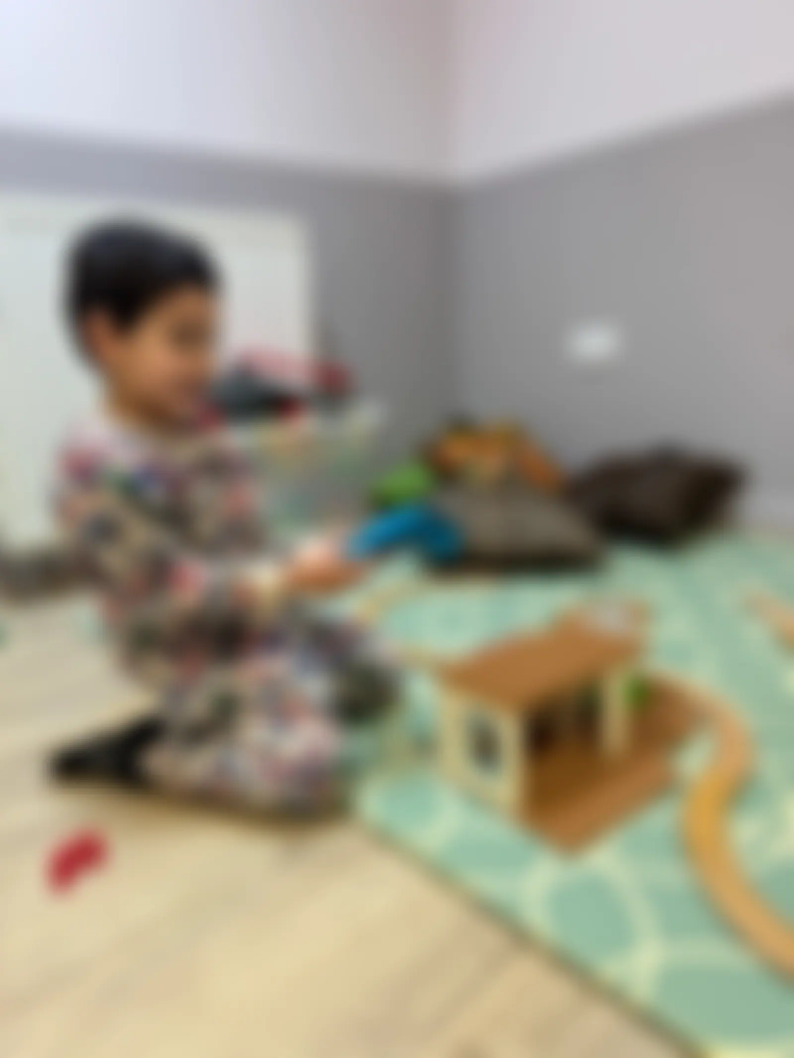 Child building a wooden train track